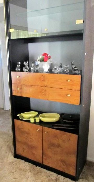 Contemporary Style  Burl Wood & Glass Display Cabinet with both glass door & glass shelf display, and open shelf display, 2 drawers and cabinet door storage with brass pulls; Also shown are collection of hand blown glass figural paperweights, and Vintage Dish Set which are also available.