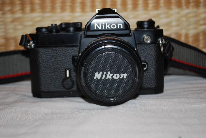 Nikon F2 35mm camera with 50mm lens, lens cap and camera strap