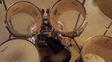 Slingerland Drum Set, newer, not-vintage: 5-pc with Slinglerland-labeled high-hat & cymbals, includes extra Tama Bass Pedal, Pearl COW BELL, an old Vintage Jazz Crash Cymbal and sticks/stick-bag (Silver, but covered in Stickers representing 80’s & 90’s counter-culture bands / skateboards / BMX).