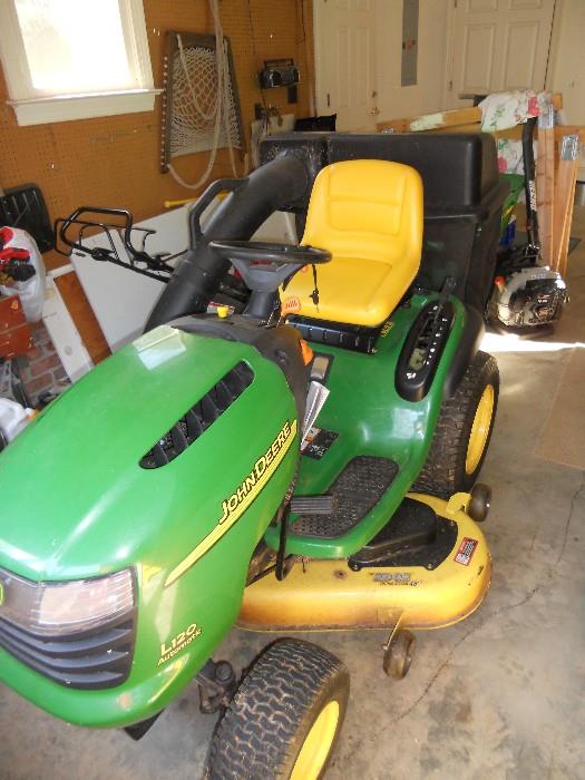 John Deere mower with attached baggers, 22 hp, engine, automatic drive, 48" cut and with only 97.5 hours of use
