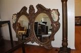 Highly gilded double mirror, with figures.