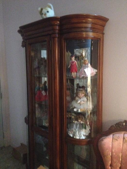 Curved glass curio cabinet & Madame Alexander dolls