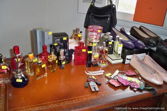 Chanel flats and designer fragrances on leather top desk