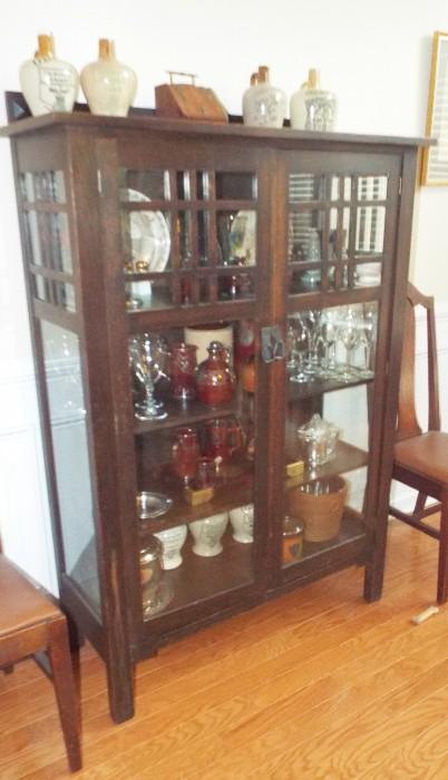 ONE OF MANY ARTS AND CRAFTS - STICKLEY ERA OAK CABINET FILLED WITH ART POTTERY AND CROCKERY