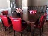 nice dining table with red pleather chairs