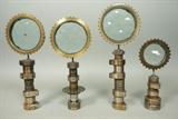 Lot 37:  Lot 4 Industrial Magiscope Sculptures. Round glass discs with ground circles. Metal steel frames & stands. All etched Bejar: Dimensions:  H: 12 inches: W: 4.75 inches --- US Shipping charge: $50