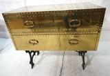 Lot 86:  Brass Two Drawer Campaign Chest Cabinet Table. SARREID Brass Trunk with studded details on Black Iron Base. Not marked: Dimensions:  H: 30.25 inches: W: 34.25 inches: D: 19.5 inches --- 