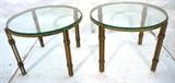 Lot 90:  Pr MAISON RAMSAY style Round Gilt Iron Side Tables. Thick glass tops. Four part metal legs with wrapped details. : Dimensions:  H: 15.5 inches: W: 20 inches: D: 20 inches --- 