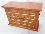 Lot 381:  Campaign style Painted Cabinet. DREXEL. Rust Orange painted two door cabinet with gold trim highlights. Metal handles. : Dimensions:  H: 30 inches: W: 43 inches: D: 19 inches --- 