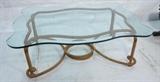 Lot 442:  Large Decorator Glass Coffee Table. Twisted Metal Rope Decorative base. Thick beveled glass shaped top. Heavy metal base.: Dimensions:  H: 18 inches: W: 37 inches: D: 50 inches --- 