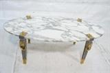 Lot 451:  P.E. Guerin Coffee Cocktail Table.  Gilt and silvered Bronze Legs with Oval Marble Top.: Dimensions:  H: 17 inches: W: 48 inches: D: 24 inches --- 