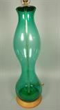 Lot 472:  Oversized Tall Green Glass Table Lamp. Corseted form. Matching green glass finial.  Wood base.: Dimensions:  H: 46 inches --- 