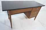 Lot 524:  American Modern Walnut Desk by STANLEY. Black Laminate top over walnut base. Aluminum pulls.: Dimensions:  H: 29.25 inches: W: 50 inches: D: 22 inches --- 