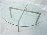 Lot 541:  70's Modern Barcelona style Coffee Cocktail Table. Round glass top on "X" base. : Dimensions:  H: 16 inches: W: 42.5 inches --- 
