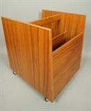 Lot 554:  BRUKSBO Norway Teak Rolling Magazine Rack. Modern two part cabinet on wheels. Label: Dimensions:  H: 17 inches: W: 13.75 inches: D: 16 inches --- 