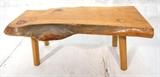 Lot 576:  Freeform wood slab coffee cocktail table bench. Four wood legs. 2.5" thick slab: Dimensions:  H: 20 inches: W: 25 inches: D: 47 inches --- 