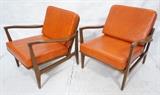Lot 625:  Pr Modern Arm Lounge Chairs. Wood arms and frames. Orange vinyl cushion seats & backs.: Dimensions:  H: 29 inches: W: 30 inches: D: 30 inches --- 