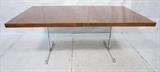 Lot 653:  MILO BAUGHMAN Rosewood Dining Table. Thick rosewood  top  with contrast banded trim. Chromed steel inverted "T" base with stretcher. Two 18.5" leaves: Dimensions:  H: 29 inches: W: 72 inches: D: 42 inches --- 