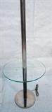 Lot 660:  Modernist Chrome Black Finish Table Floor Lamp. Thick column form with round glass top. : Dimensions:  H: 57 inches: W: 18 inches: D: 18 inches --- 