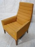 Lot 673:  DUNBAR Modern Tall Back Lounge Arm Chair. Channel form pale orange upholstery.  Tapered square wood legs. Metal DUNBAR style.: Dimensions:  H: 39 inches: W: 28 inches: D: 29 inches --- 