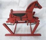 Lot 681:  Red Painted Vintage Child's Hobby Horse. Painted wood on spring base: Dimensions:  H: 29 inches: W: 36 inches: D: 19 inches --- 