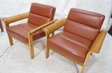 Lot 686:  Pr Danish Modern Wide Arm RUDD Co Lounge Chairs. Blond wood frames with rust vinyl upholstery. : Dimensions:  H: 28 inches: W: 30 inches: D: 28 inches --- 