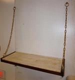 Lot 698:  Decorator Hanging Wall Shelf. Travertine slab on wood shelf. Gilt metal chain support and shelf brackets: Dimensions:  H: 58 inches: W: 48 inches: D: 18 inches --- 