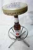 Lot 704:  Lite beer advertising bar stool. Bottle pedestal with chrome foot rest. Seat is designed like bottle cap: Dimensions:  H: 30.75 inches: W: 25 inches --- 