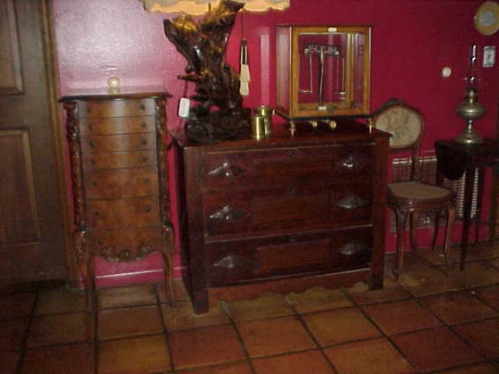 Jewelry chest with necklace door on each side, hidden compartment below the last drawer. Palo-Myers Jeweler's scale, Mini cane seat Victorian chair, repaired leg. Three drawer Victorian chest. Rayo Lamp.