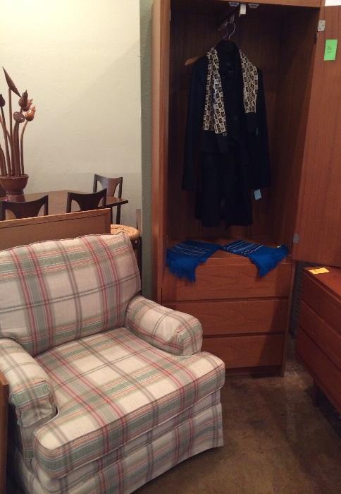 Teak cabinet and plaid chair.