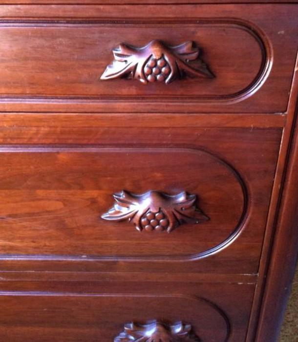 Intricately carved grape and leaf pulls, now a famed hallmark of the design.
