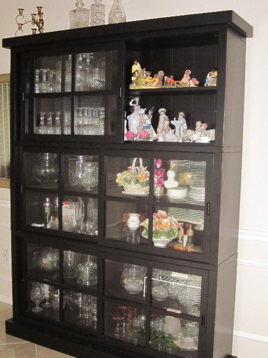 Stacking display cabinets with sliding doors. They are separate pieces you arrange how you wish. Total of four cabinets in the house.