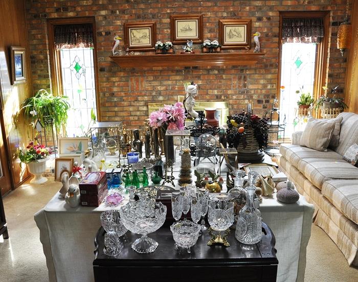 A view of  the the crystal and decor items  in the den.  There is also a full size sofa, wrought iron birdcage and plant stands and a blooming orchid!