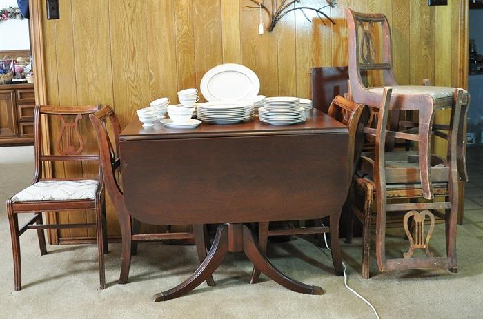 Vintage Duncan Phyfe drop leaf table with one leaf and 6 chairs.  The table was stored in the garage and 3 of the chairs were in the attic.  A very good project group.
