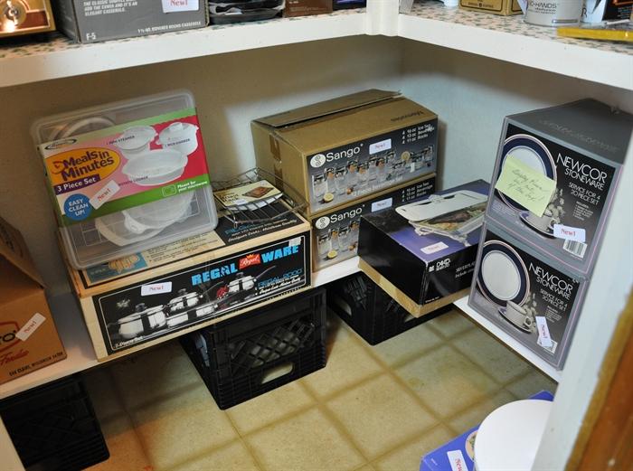 Kitchen pantry is full of new in the box items including an ice cream freezer, 5 can openers, pyrex, corning, etc.