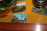 A few post cards inside the display table.