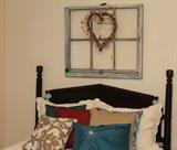 The head board of the antique mahogany bed. Foot board and rails are on the patio.