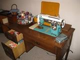 vintage sewing machine with table and sewing supplies, also have yarn and knitting/crochet needles