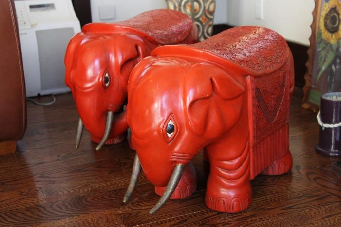 Carved cinnabar elephant garden stools with brass tusks
