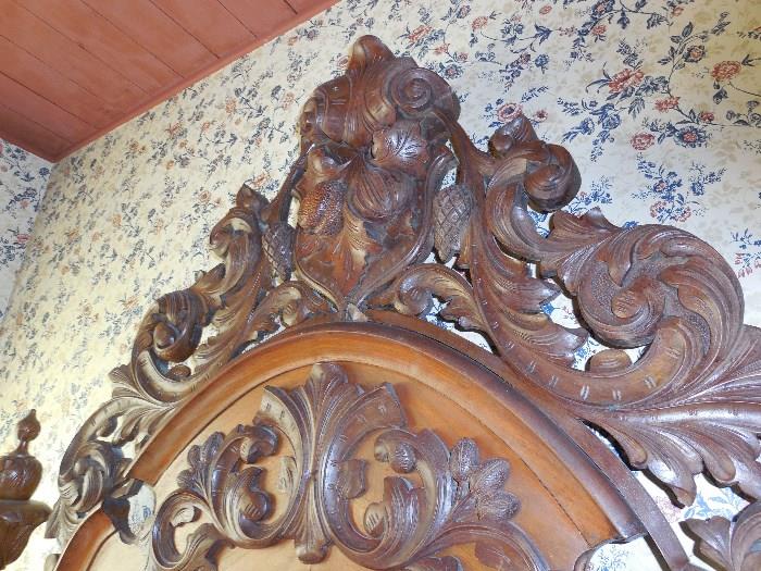 Close up photo of carved Victorian bed, headboard