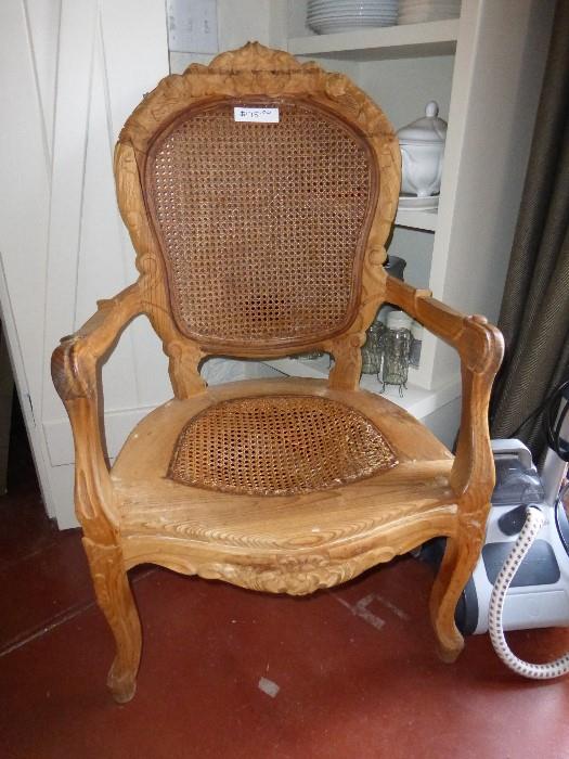 carved chair with cane seat and back