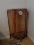terrible picture but is a vintage curio cabinet w/clock in middle
