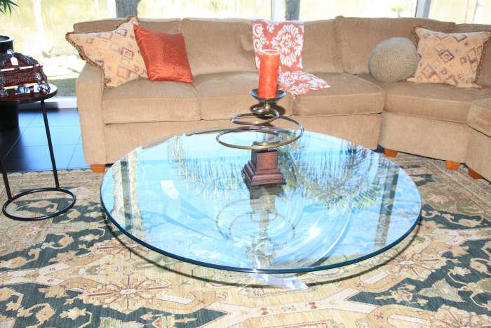 The Lucite base of this "octopus" coffee table is topped with beveled glass. 