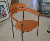 Set of six modern high-style dining chairs constructed of tubular steel and fine Italian leather.  Designed by Larson and  made by Italia.