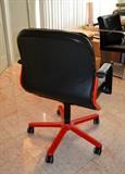 Pair of leather executive chairs with red bases (Merchandise Mart)