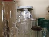 Antique glass jars, some have lids and some don't.