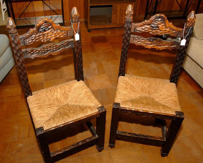 Antique hand carved chairs with woven seats.