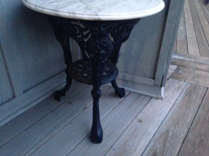 iron figural table with bevelled marble top