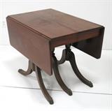 Lot #1110 Mahogany drop leaf table with 3 pedestal legs