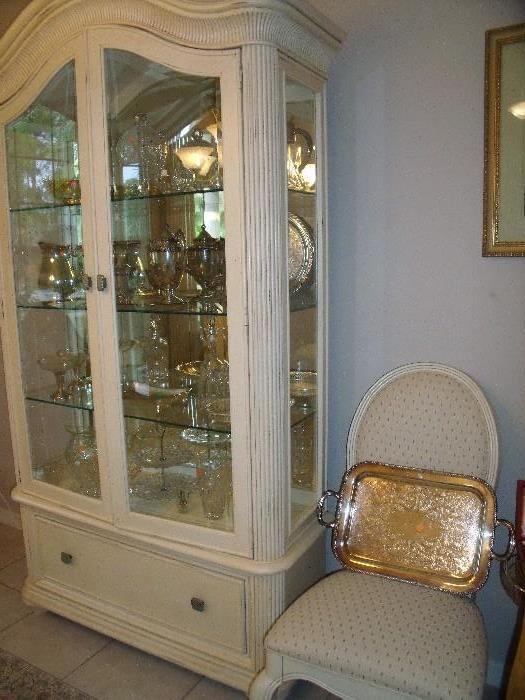 China cabinet (part of set).  Silver tray on one of the dining table chairs